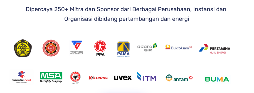 woman wearing a headwrap and an Africa-shaped earring while smiling